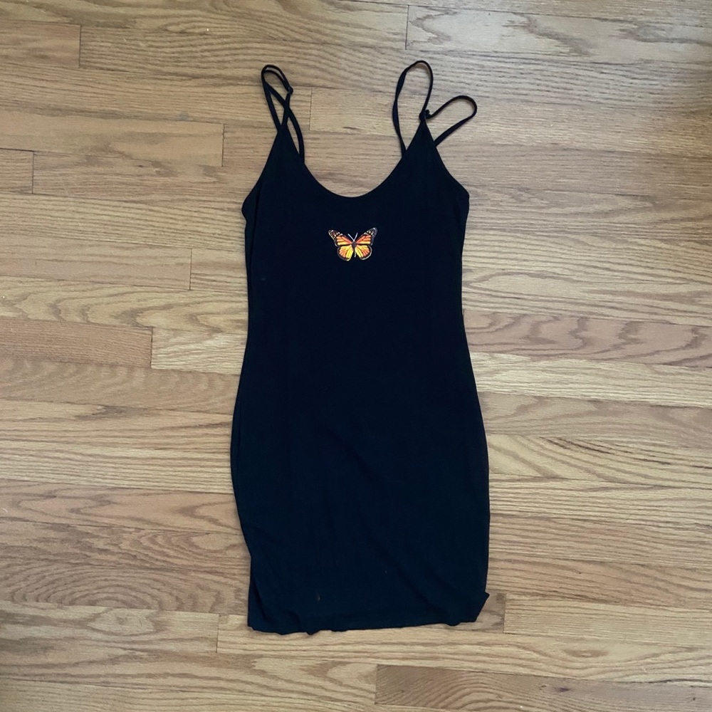 Tight black mini dress with butterfly emblem